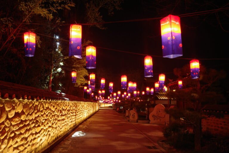 A beautifully lit street in Namwon, South Korea, adorned with colorful hanging lanterns at night.